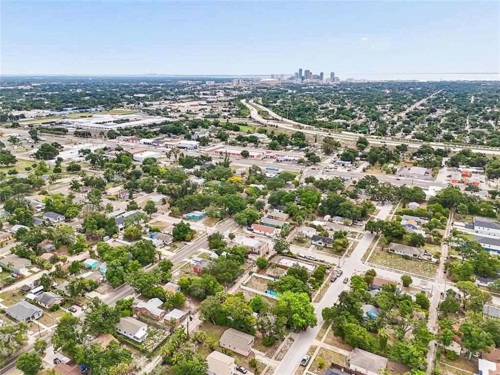 An aerial view shows a residential neighborhood with a distant city skyline in the background — 3603 16TH AVENUE S, ST PETERSBURG, FL