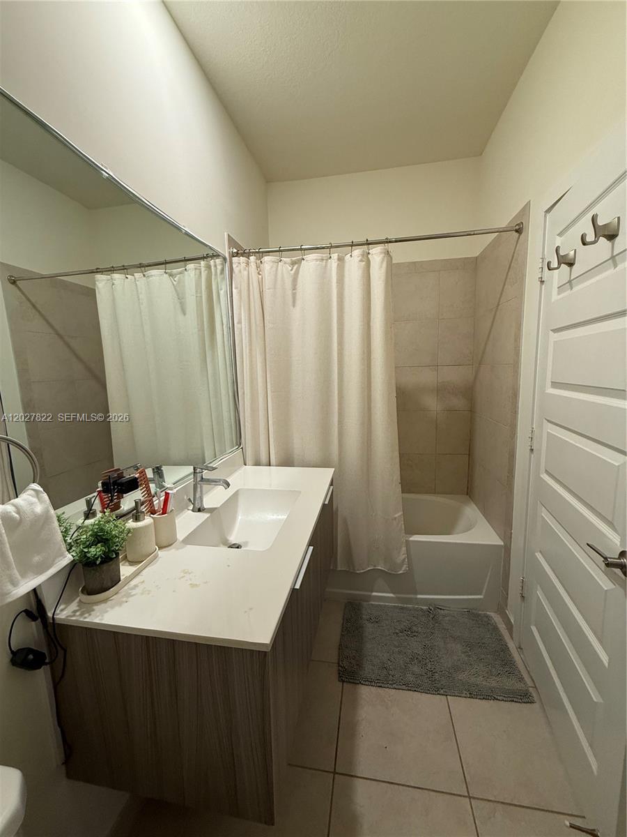 A bathroom features a white vanity, a large mirror, and a shower-tub combination — 7815 NW 104th Ave # 32, Doral FL 33178, DORAL, FL