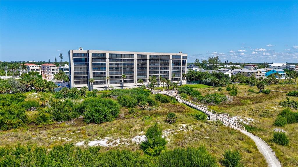 An exterior walkway features a gray door marked 508, a window, and tiled flooring — 420 BEACH ROAD UNIT 508, SARASOTA, FL