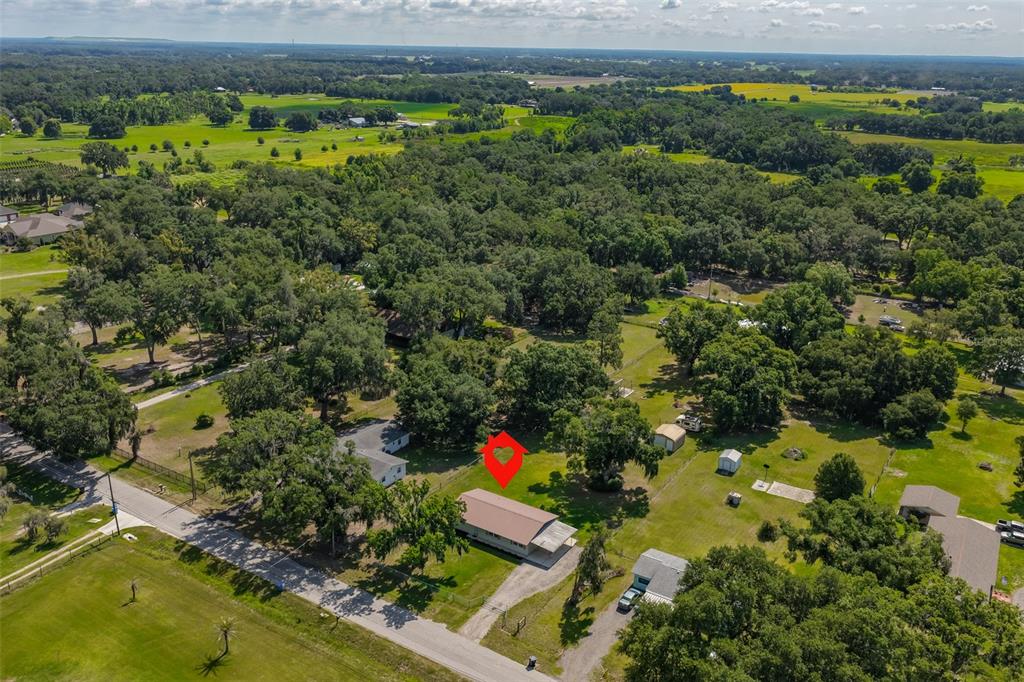 An aerial view shows a single-story house with a metal roof on a rural lot — 4306 STRAUSS ROAD, PLANT CITY, FL