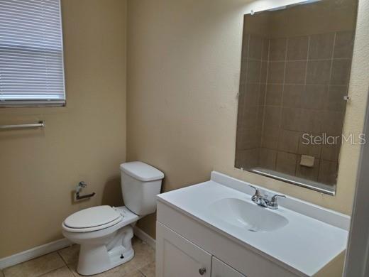 An entryway with a white front door leads into an adjacent room with wood flooring — 2411 E 18TH AVENUE, TAMPA, FL