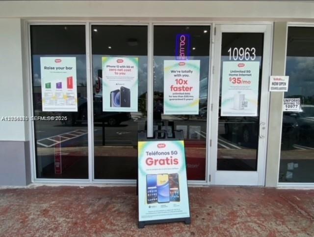 The exterior of a retail storefront features glass doors and windows with promotional signage — 740 W 49 st, Hialeah FL 33012, HIALEAH, FL