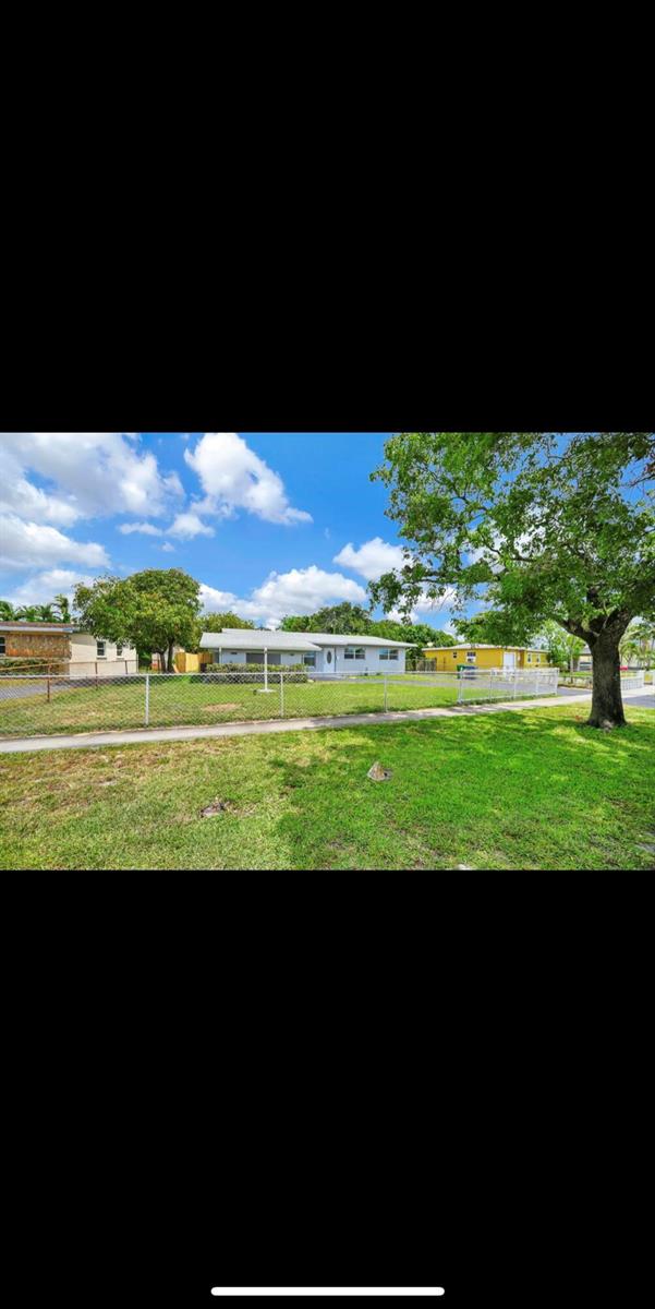 A single-story house with a chain-link fence sits behind a grassy lawn and sidewalk — 1112 NW 43rd Terrace, Lauderhill FL 33313, LAUDERHILL, FL
