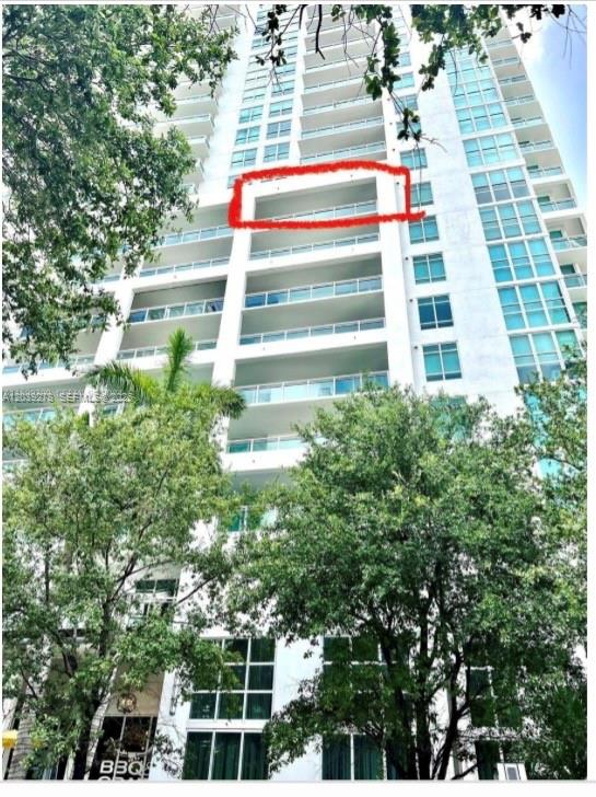 A low-angle exterior view of a high-rise residential building with a red-circled balcony — 951 Brickell ave # 709, Miami FL 33131, MIAMI, FL