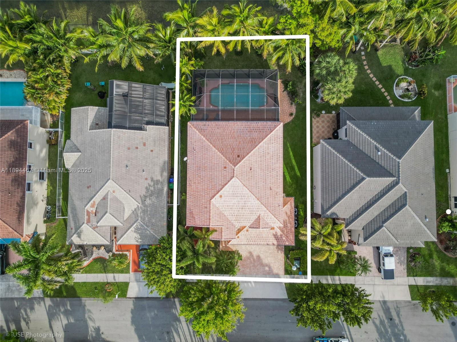 An aerial view shows a house with a tiled roof, a screened pool, and landscaping — 3181 SW 173rd Ter, Miramar FL 33029, MIRAMAR, FL
