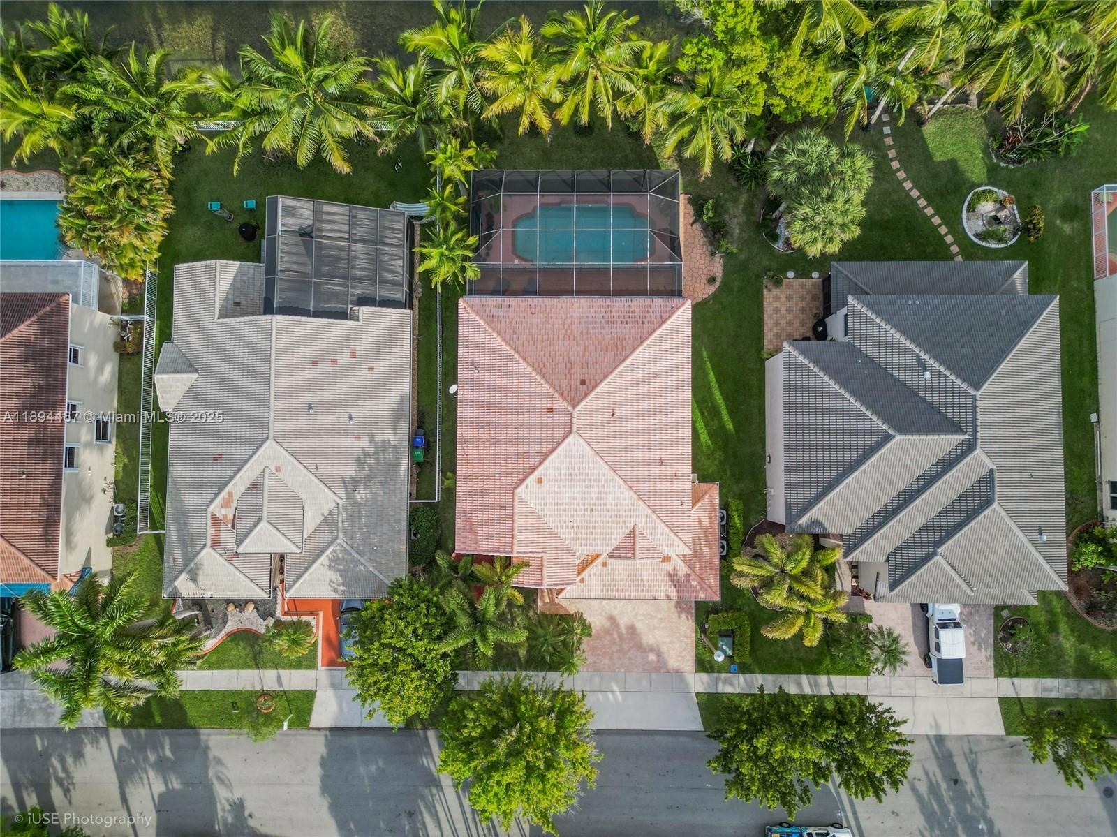 An aerial view shows three suburban houses with tiled roofs, swimming pools, and palm trees — 3181 SW 173rd Ter, Miramar FL 33029, MIRAMAR, FL