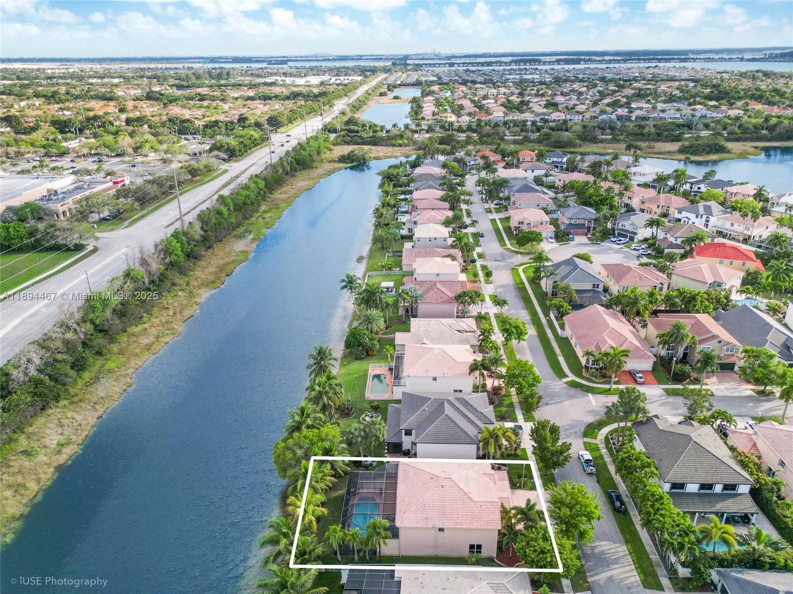 An aerial view shows a single-family home with a screened pool along a canal — 3181 SW 173rd Ter, Miramar FL 33029, MIRAMAR, FL