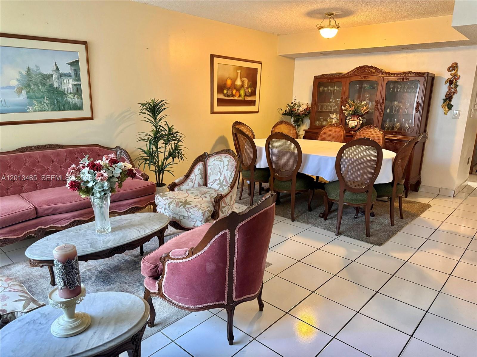 A living and dining room area features vintage-style furniture, tiled floors, and a wooden hutch — 10330 SW 154th Cir Ct # 51, Miami FL 33196, MIAMI, FL