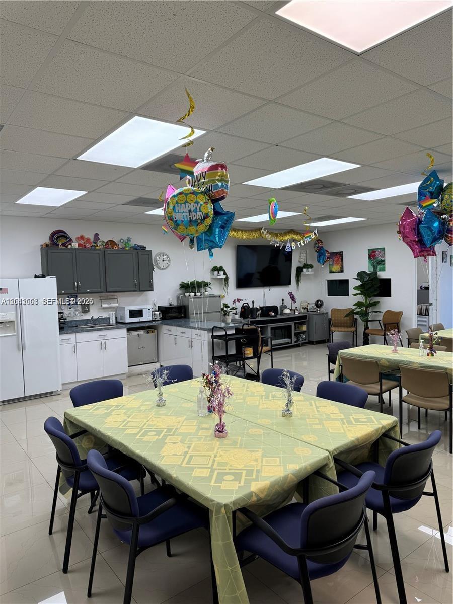 This room features a dining area with tables, chairs, and birthday balloons under a drop ceiling — 0000 W 20th Ln, Hialeah FL 33016, HIALEAH, FL