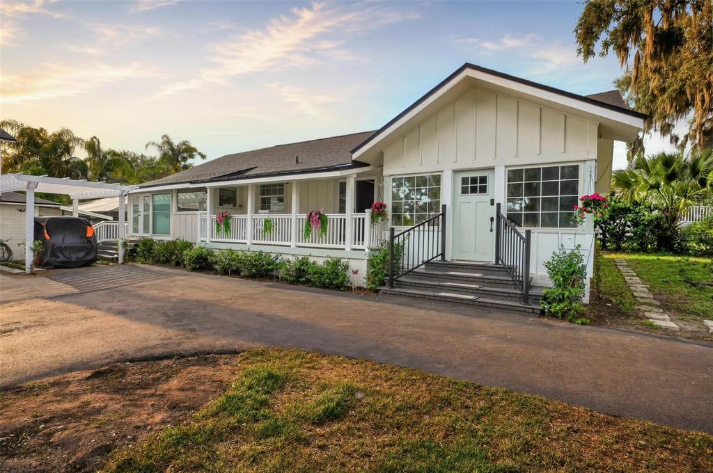 A kitchen with white cabinets, stainless steel appliances, and light wood flooring — 1099 GROVE AVENUE, MOUNT DORA, FL