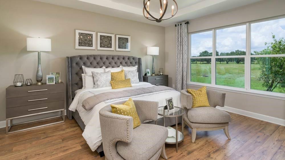 A bedroom features a tufted headboard, two armchairs, a side table, and large windows — 3614 PINE PEAK LOOP, PLANT CITY, FL