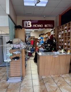 This retail store interior features a service counter, wooden shelving units, and a shoe display — 11402 NW 41 st, Doral FL 33178, DORAL, FL