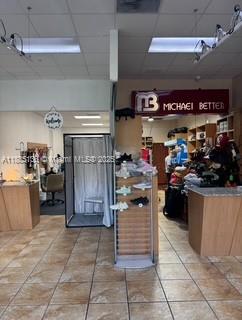 This retail space features a fitting room, a display shelf, and a branded storefront sign — 11402 NW 41 st, Doral FL 33178, DORAL, FL