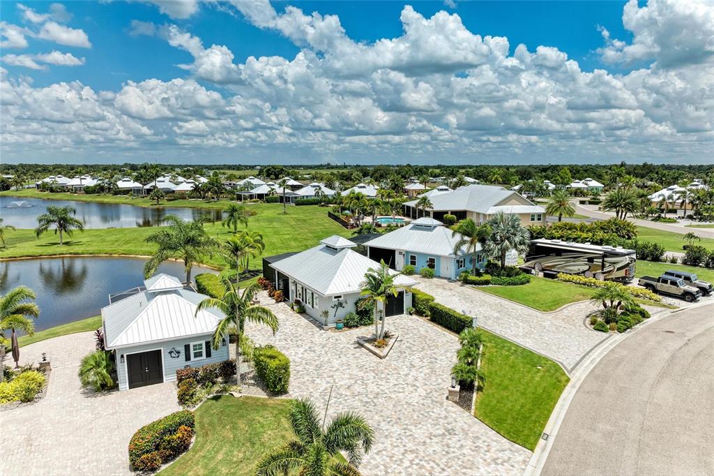 An aerial view shows a residential property with multiple buildings, a paved driveway, and landscaping — 8414 SW SAND CRANE CIRCLE LOT 82, ARCADIA, FL
