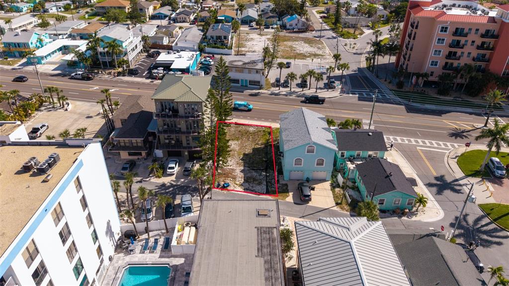 An aerial view shows a vacant lot outlined in red between two residential buildings — 13304 GULF BOULEVARD, MADEIRA BEACH, FL