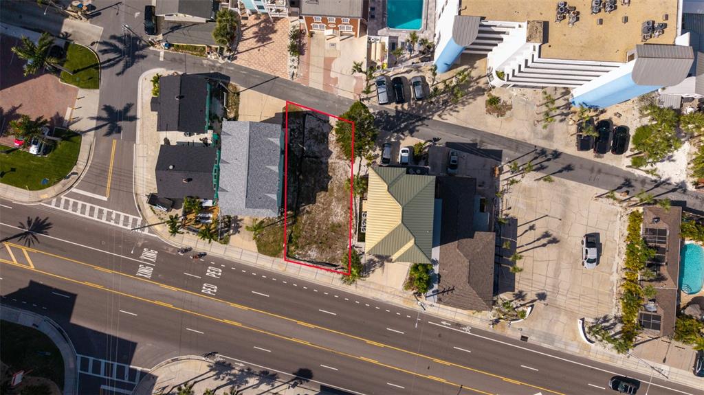 An aerial view shows a vacant rectangular lot outlined in red between two existing buildings — 13304 GULF BOULEVARD, MADEIRA BEACH, FL