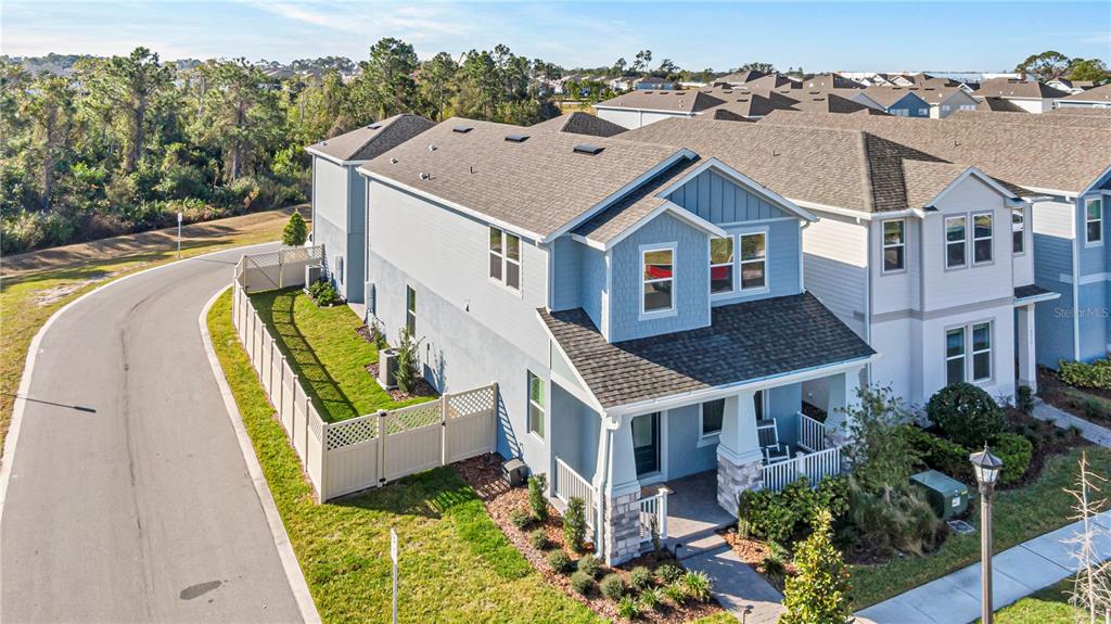 An aerial view of a light blue two-story house with a fenced side yard — 16271 HONEY HARVEST STREET, WINTER GARDEN, FL
