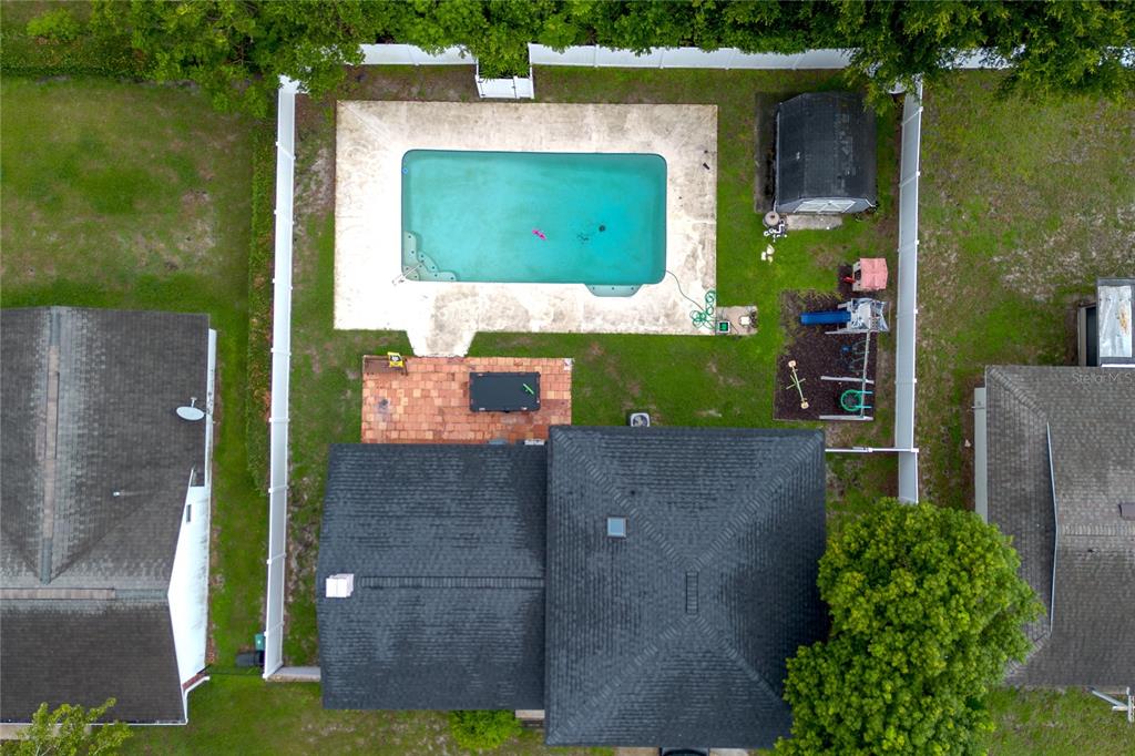 An aerial view shows a backyard with a swimming pool, patio, shed, and playground equipment — 103 CASHEW COURT, LONGWOOD, FL