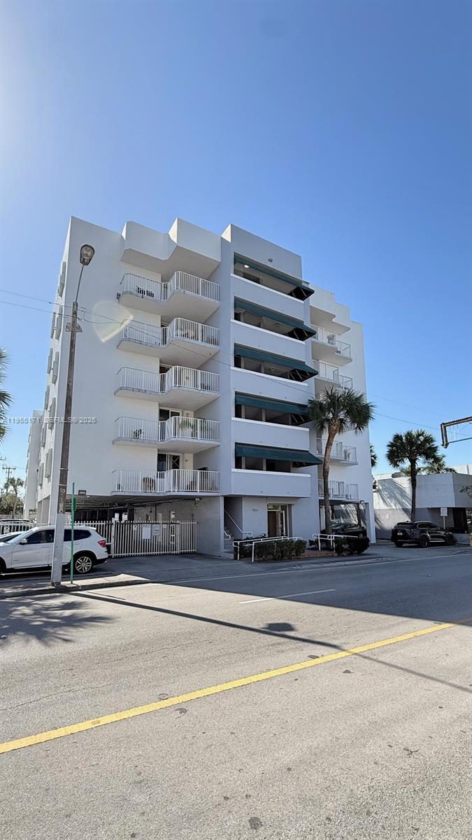 A multi-story white apartment building features stacked balconies and dark green awnings — 4854 NW 7th St # 508, Miami FL 33126, MIAMI, FL