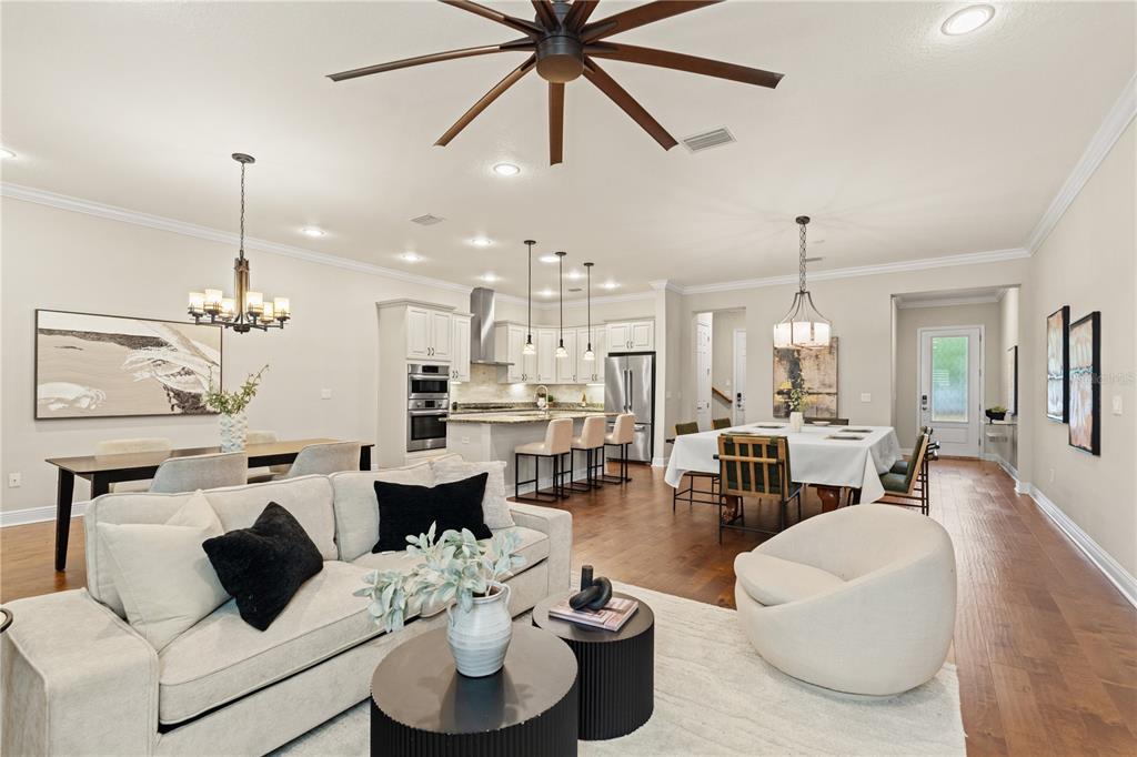 An open-concept living and dining area features a kitchen with a large island and seating — 606 S LINCOLN AVENUE UNIT 2, TAMPA, FL