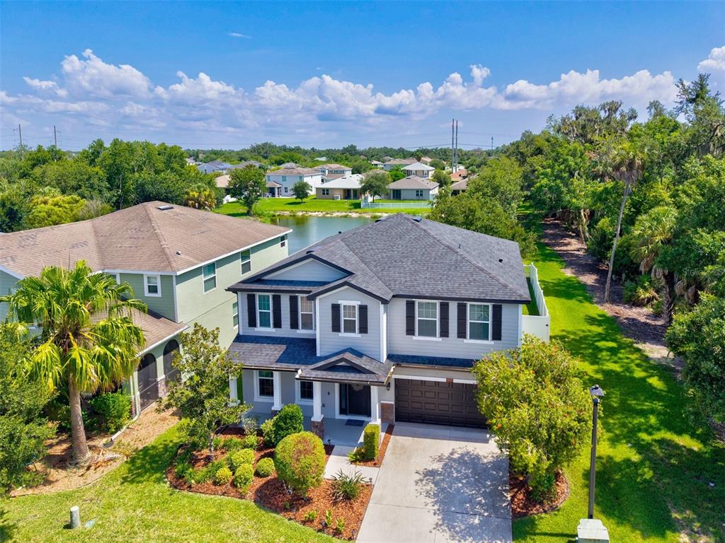 An aerial view of a two-story suburban house with a gray exterior and attached garage — 5703 NEW PARIS WAY, ELLENTON, FL