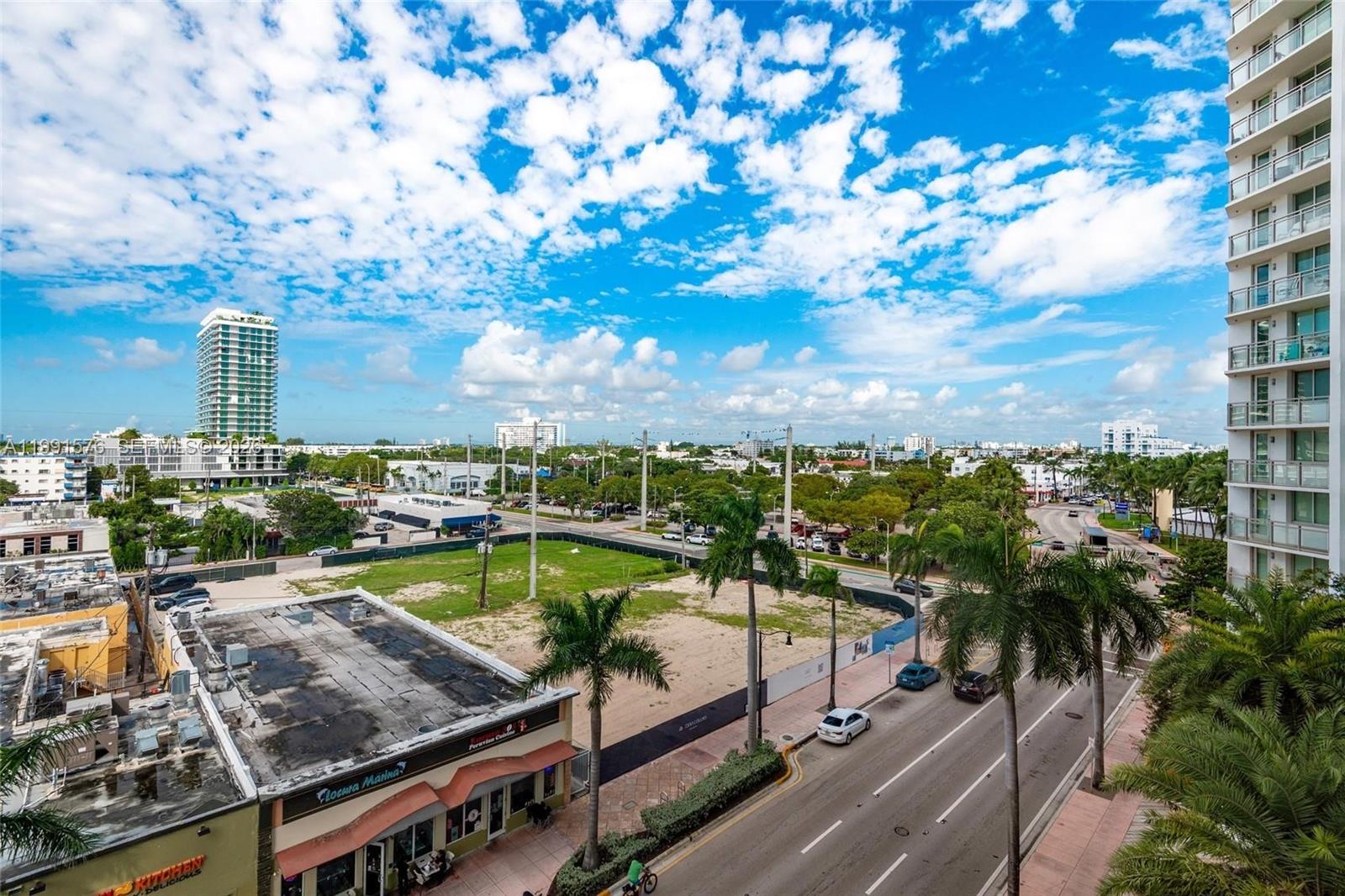 An elevated view shows a city street, palm trees, a vacant lot, and surrounding buildings — 7135 Collins Ave # 625, Miami Beach FL 33141, MIAMI BEACH, FL