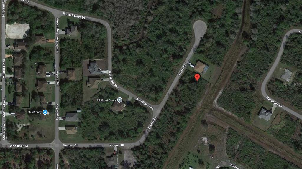 This is a satellite map view showing residential streets, wooded lots, and a marked property — 1928 VESPER COURT, LEHIGH ACRES, FL
