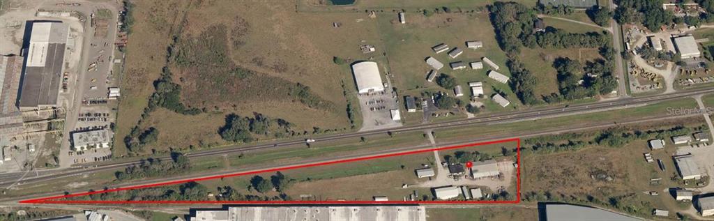 An aerial view shows a triangular plot of land outlined in red containing several buildings — 2295 US HIGHWAY 92 E, PLANT CITY, FL