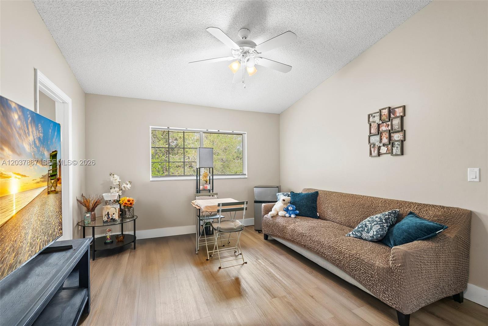 A living room features a brown sofa, a small dining set, and a ceiling fan — 3690 N 56th Ave # 948, Hollywood FL 33021, HOLLYWOOD, FL