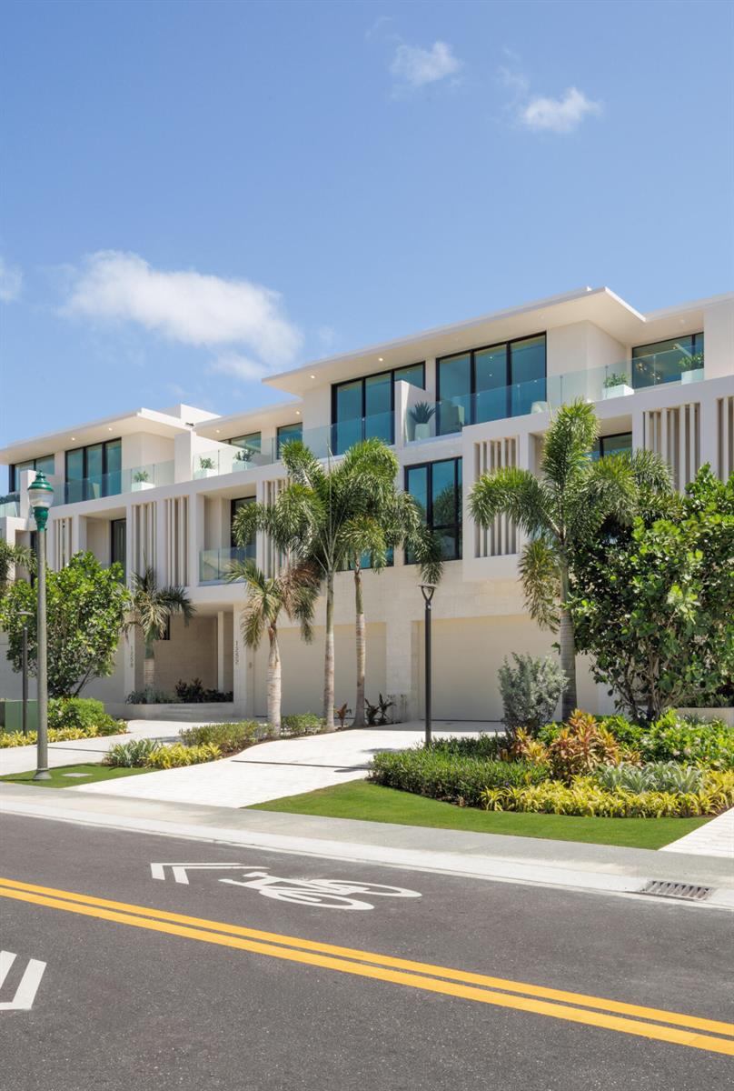 A modern multi-story townhouse with white exterior walls, glass balconies, and palm trees in front — 1258 George Bush Boulevard, Delray Beach FL 33483, DELRAY BEACH, FL