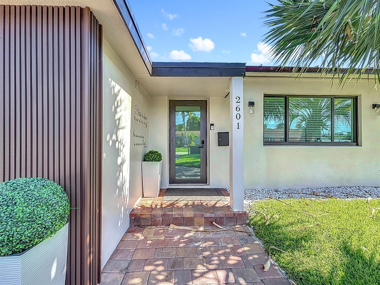 A front entryway features a brick walkway, a glass door, and a vertical house number sign — 2601 NE 18th Street, Pompano Beach FL 33062, POMPANO BEACH, FL