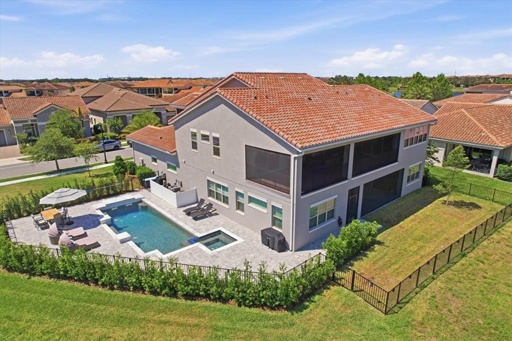 An aerial view of a two-story house with a screened-in patio and a swimming pool — 10123 BUCKLOW HILL DRIVE, ORLANDO, FL