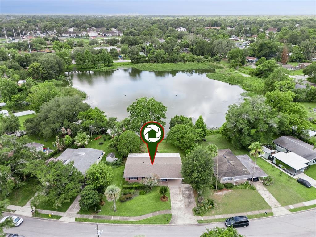 An aerial view shows a single-story house with a lake in the backyard — 812 AGNES DRIVE, ALTAMONTE SPRINGS, FL