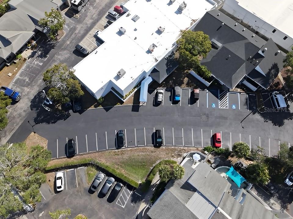 An aerial view shows a commercial building with an adjacent parking lot and surrounding trees — 617 LAKEVIEW ROAD UNIT A, CLEARWATER, FL