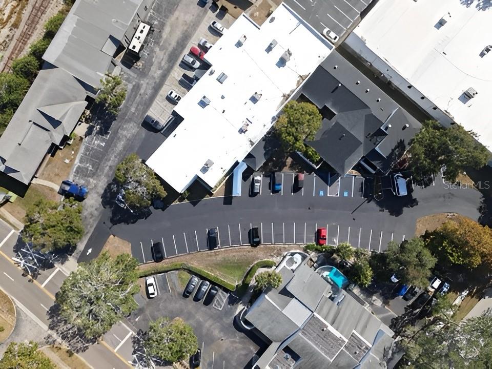An aerial view shows commercial buildings, parking lots, and surrounding trees — 617 LAKEVIEW ROAD UNIT A, CLEARWATER, FL