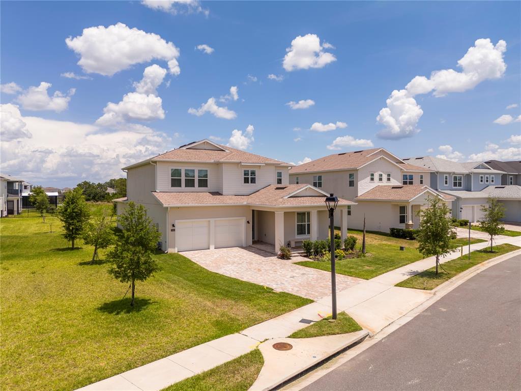 An exterior view of a two-story suburban house with a paved driveway and green lawn — 13181 TOOLCROSS WAY, WINTER GARDEN, FL