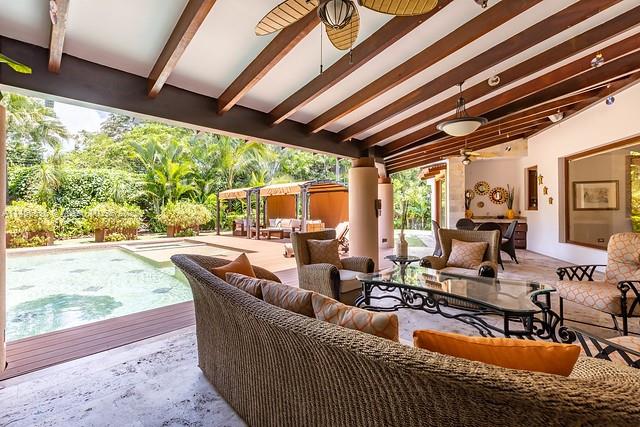 An open-air living room features wicker furniture, a wooden beamed ceiling, and a swimming pool — 800 S Del Cementerio, CR 0000, CR