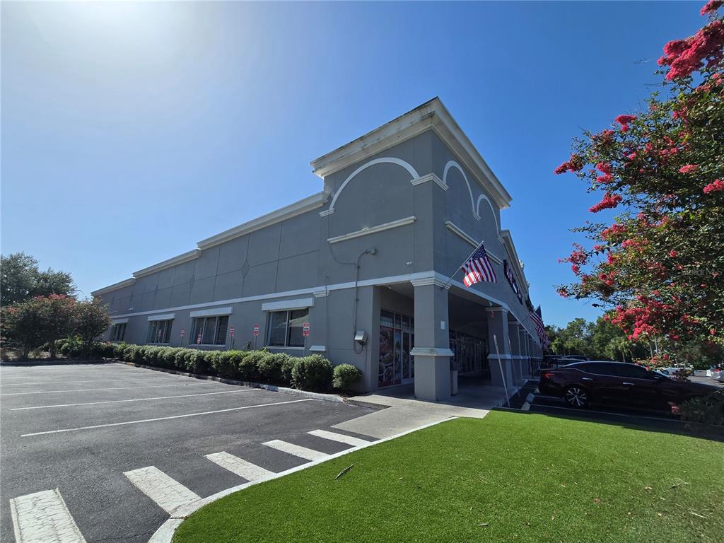A gray commercial building with a parking lot and a patch of green grass — 13605 SR 535 UNIT 102, ORLANDO, FL