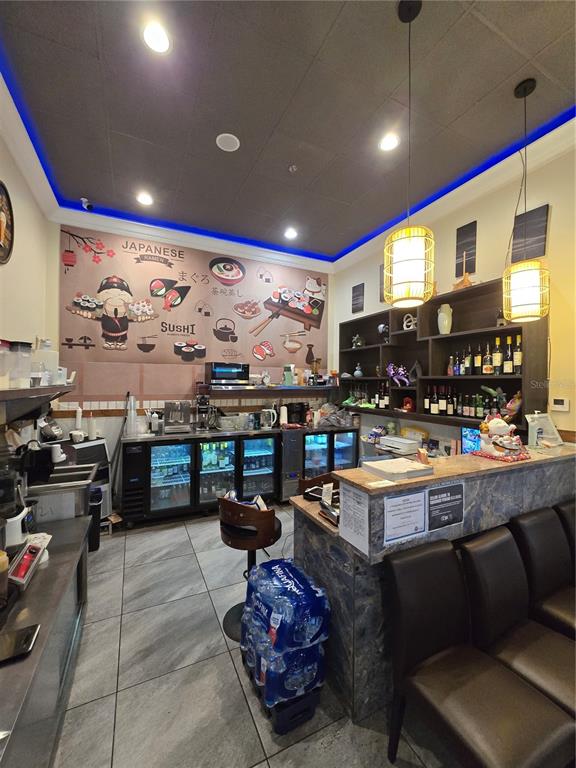 A restaurant service area features a sushi-themed wall mural, under-counter refrigerators, and bar seating — 13605 SR 535 UNIT 102, ORLANDO, FL