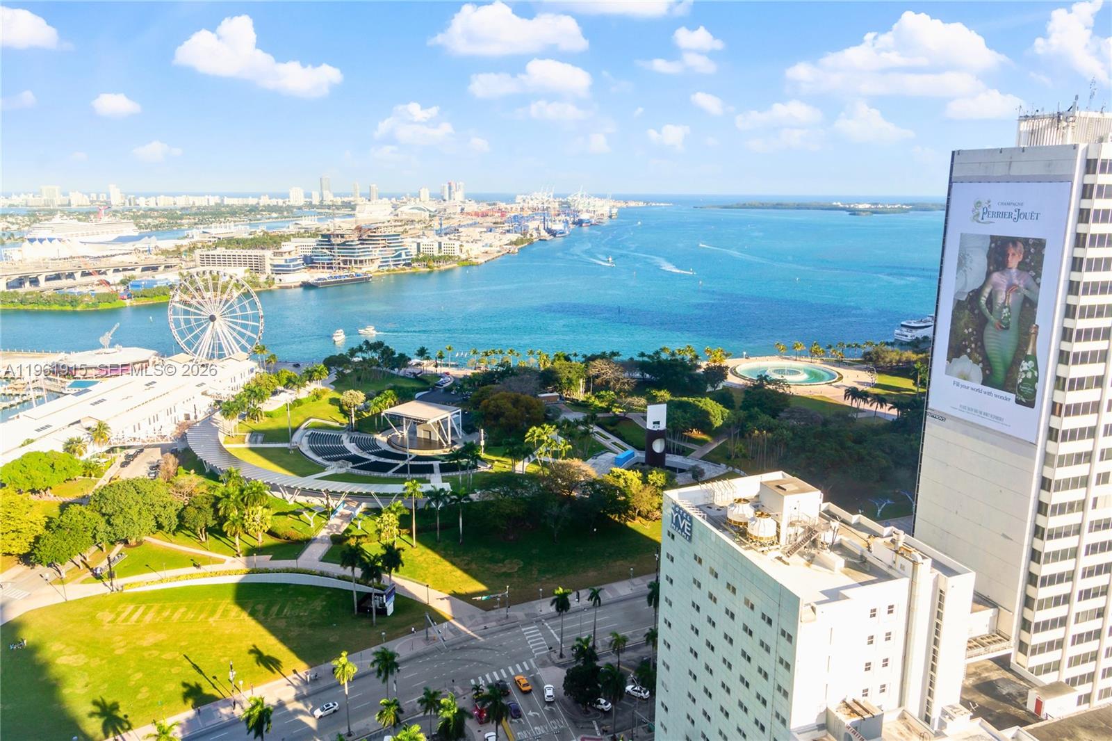 An aerial view shows a park with a ferris wheel, a waterfront, and city buildings — 253 NE 2nd St # 3105, Miami FL 33132, MIAMI, FL