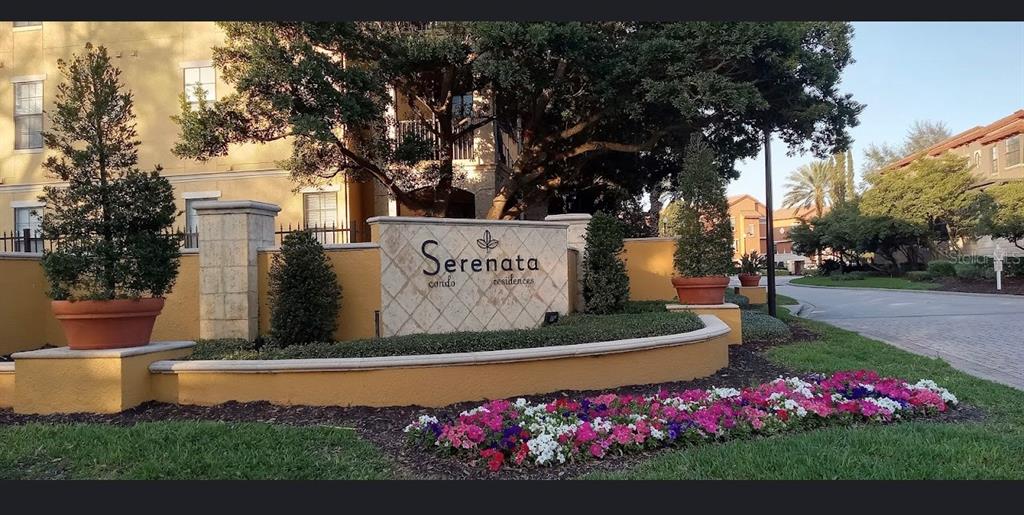 A stone monument sign for Serenata Condo Residences sits in front of a multi-story building — 6137 METROWEST BOULEVARD UNIT 307, ORLANDO, FL