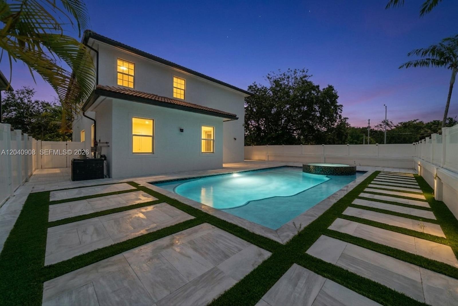 A two-story white house features a backyard swimming pool with a spa and paver patio — 3040 SW 44th Ct, Dania Beach FL 33312, DANIA BEACH, FL