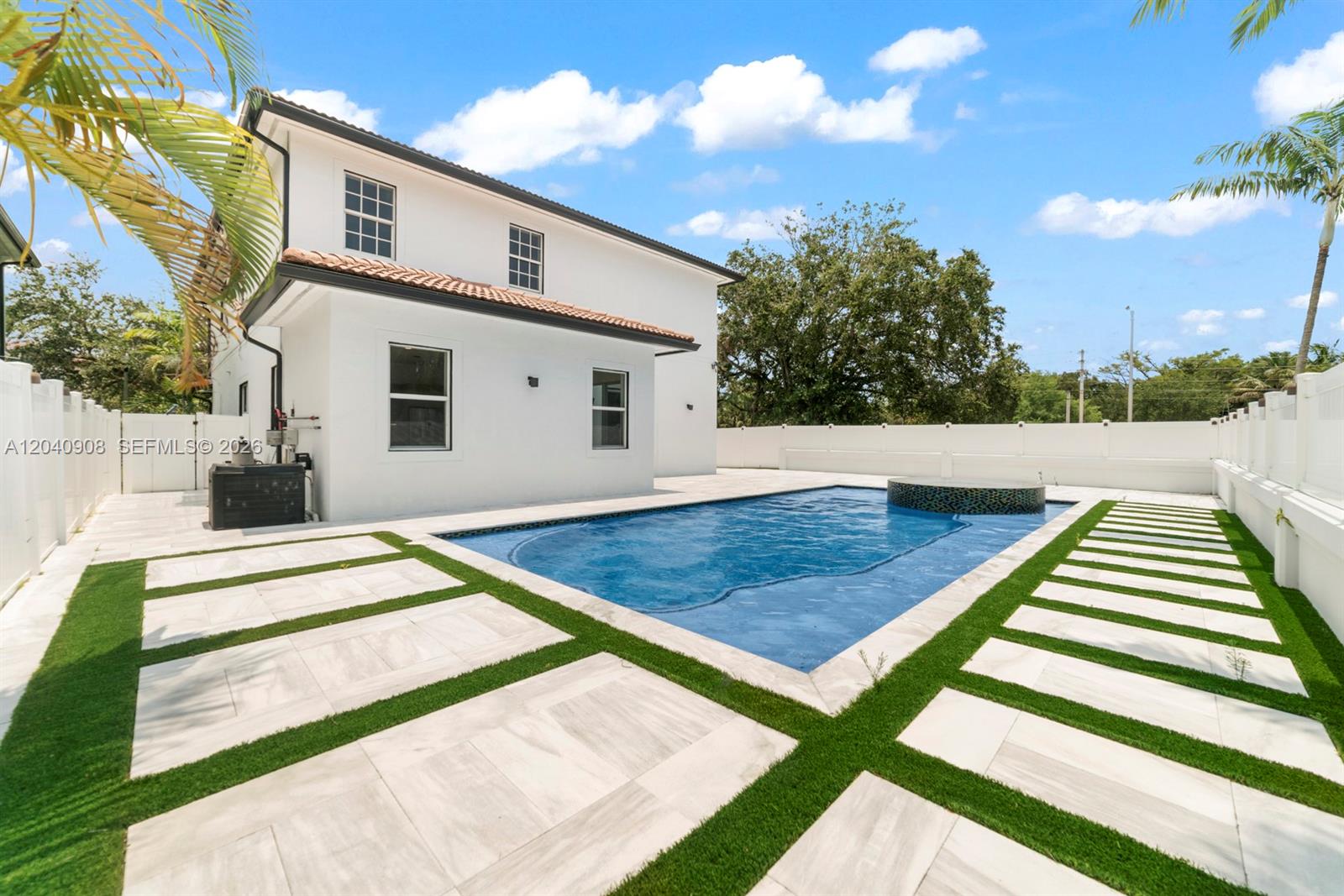 A two-story white house features a backyard swimming pool with a tiled spa and patio — 3040 SW 44th Ct, Dania Beach FL 33312, DANIA BEACH, FL