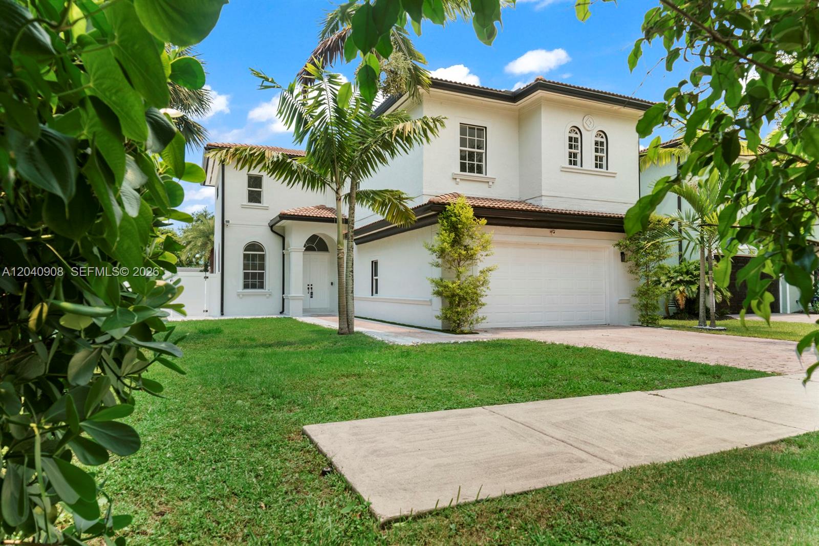 A two-story white stucco house with a tiled roof and a two-car garage — 3040 SW 44th Ct, Dania Beach FL 33312, DANIA BEACH, FL