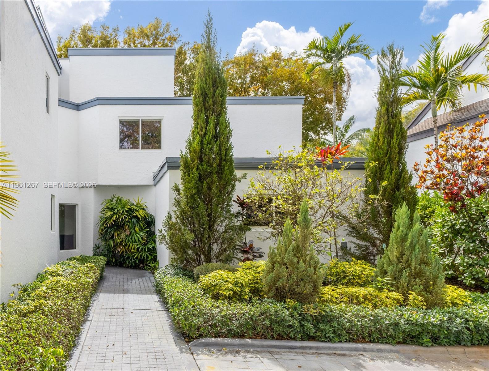 A kitchen features white cabinetry, dark marble countertops, and a stainless steel oven — 20205 W Oak Haven Cir, Miami FL 33179, MIAMI, FL
