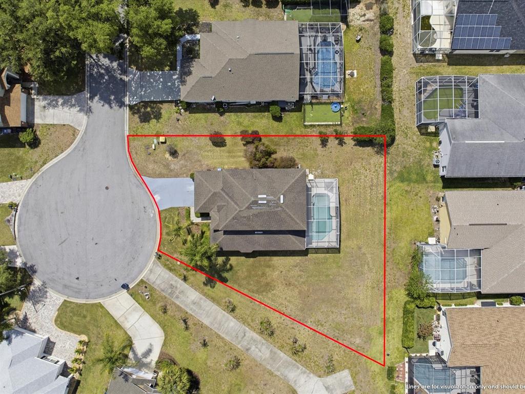 An aerial view shows a house with a pool and a large yard on a cul-de-sac — 1656 DUNES COURT, HAINES CITY, FL