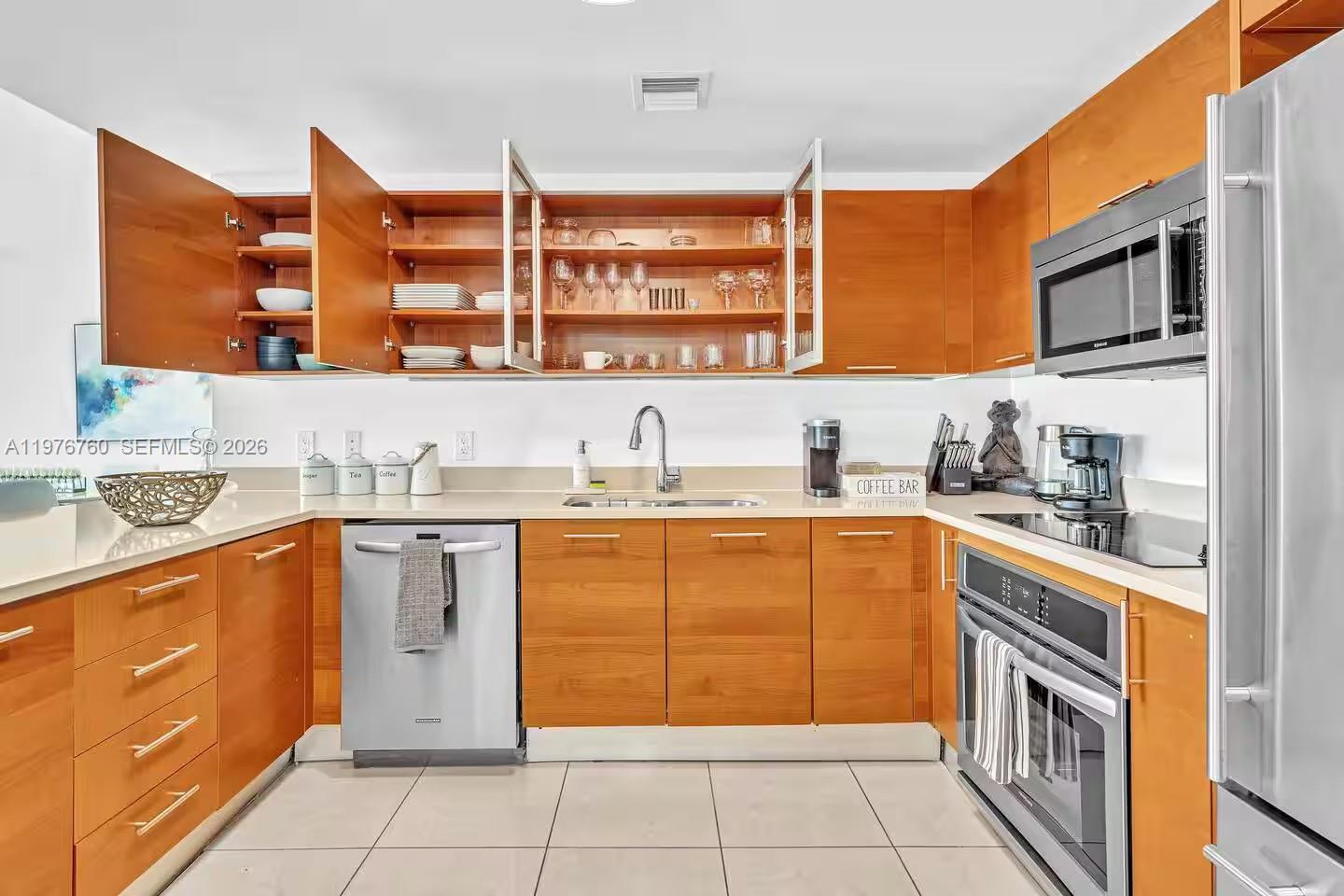 A kitchen features light wood cabinets, stainless steel appliances, and white countertops — 3250 NE 1st Ave # 501, Miami FL 33137, MIAMI, FL
