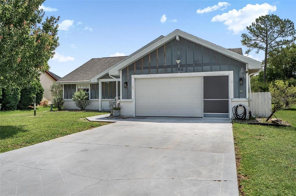 A single-story house with a gray exterior, white brick accents, and a concrete driveway — 186 WESTHAMPTON DRIVE, PALM COAST, FL