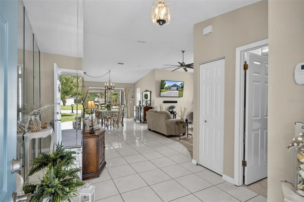 A bright entryway with tiled floors leads to an open living area and dining space — 186 WESTHAMPTON DRIVE, PALM COAST, FL