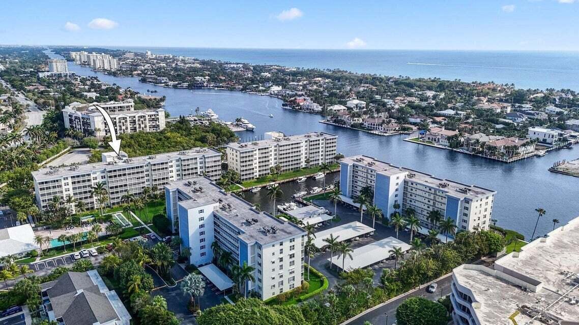 An aerial view of waterfront apartment buildings surrounded by palm trees and a canal — 1 Harbourside Drive # 4205, Delray Beach FL 33483, DELRAY BEACH, FL